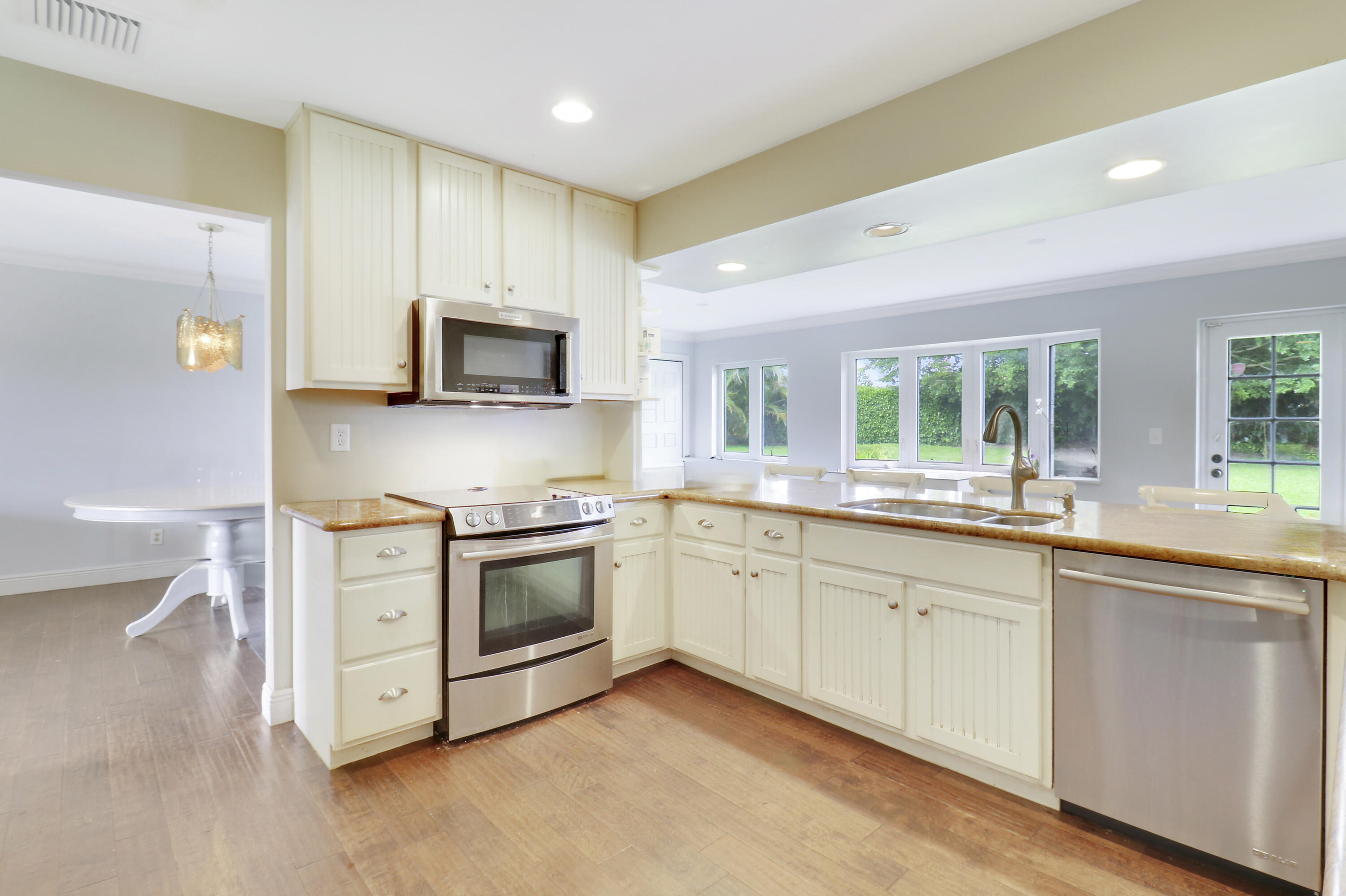 749 Cruiser Road North North Palm Beach, FL 33408 - Photo 10 of 46 a kitchen with a stove top oven sink and cabinets