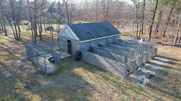 a view of house with yard and garage