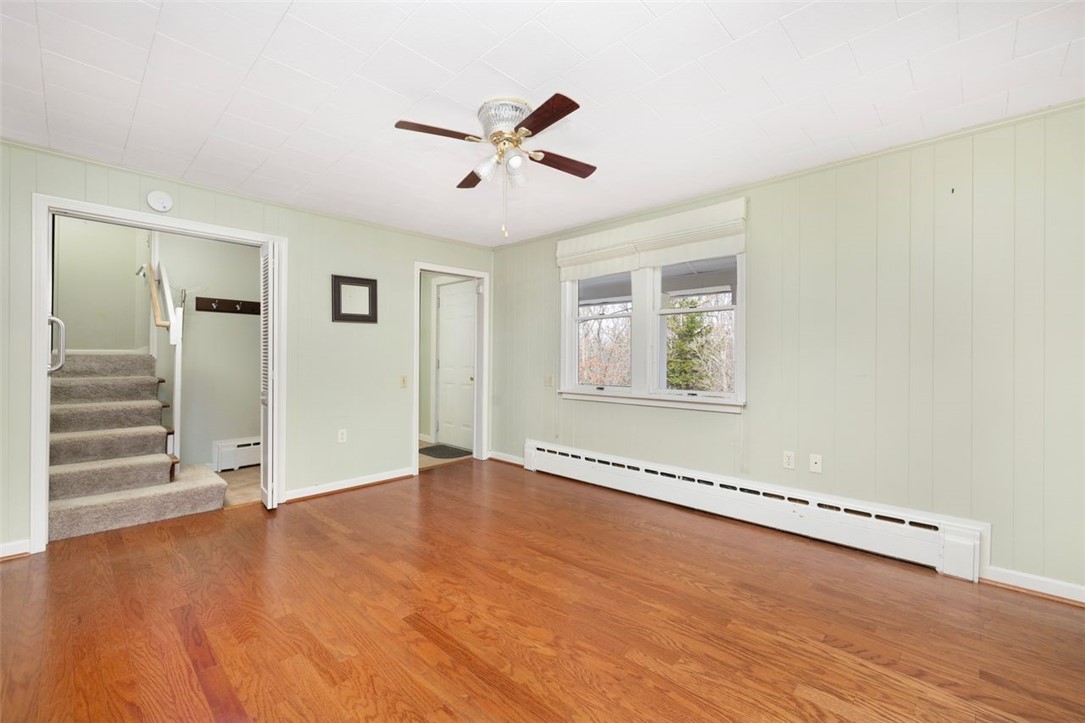 270 Buckeye Brook Road Charlestown, RI 02813 - Photo 8 of 45 Living room to front door and stairs to second level