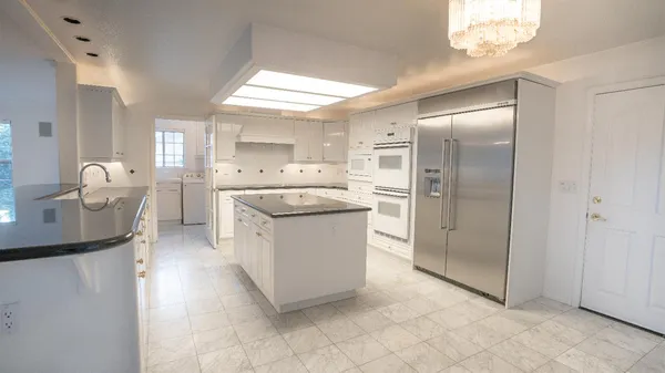 a kitchen with a refrigerator sink and stove