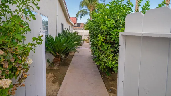 a view of a pathway with a white house