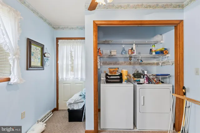 a living room with furniture and a dining table