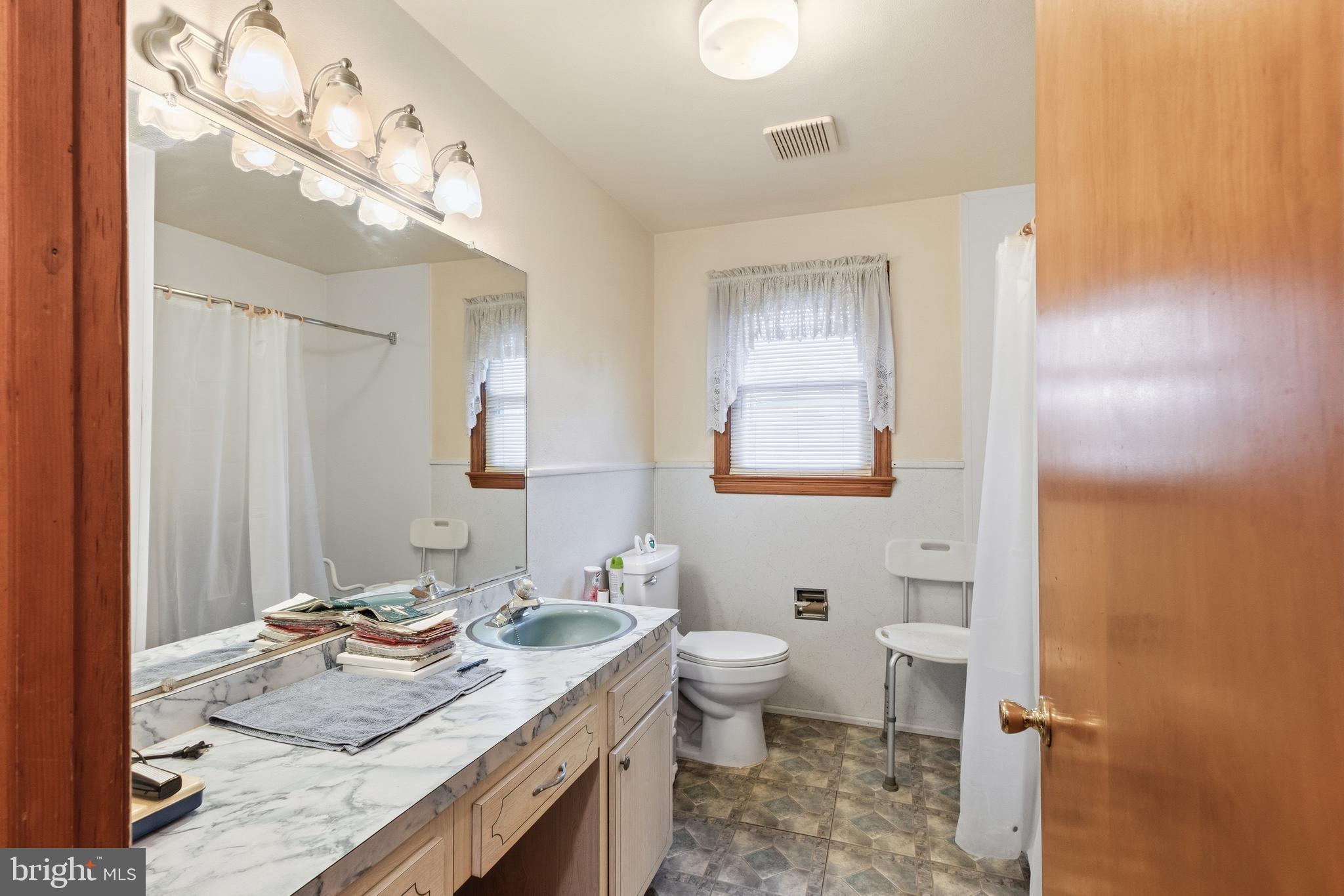 961 Canterbury Road Milford, DE 19963 - Photo 18 of 27 a bathroom with a granite countertop sink mirror vanity and toilet