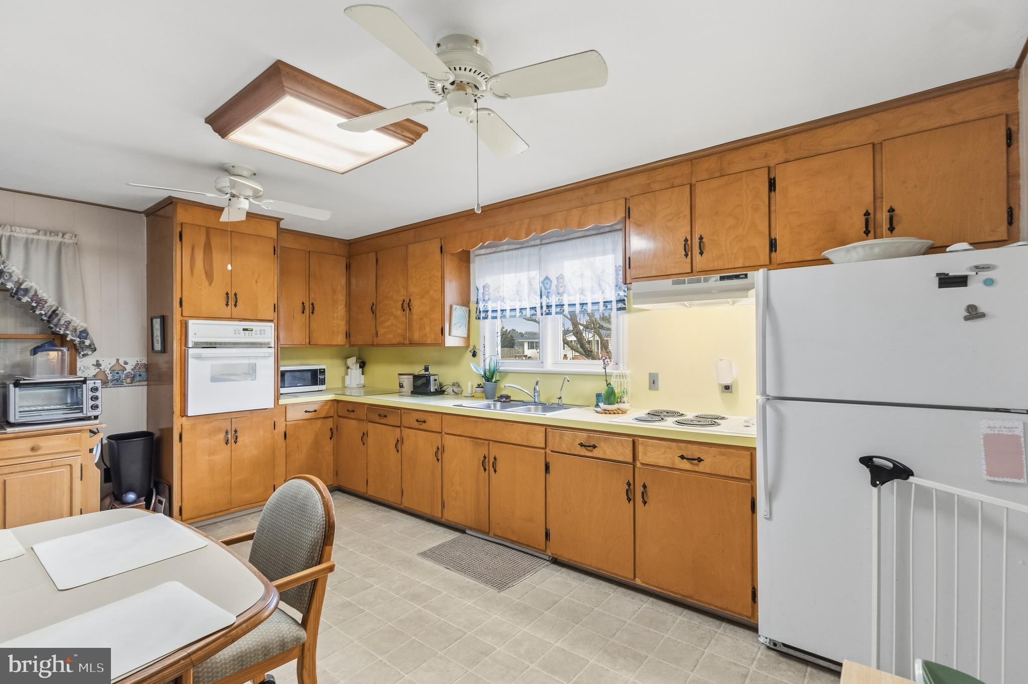 961 Canterbury Road Milford, DE 19963 - Photo 5 of 27 a kitchen with cabinets a sink and appliances