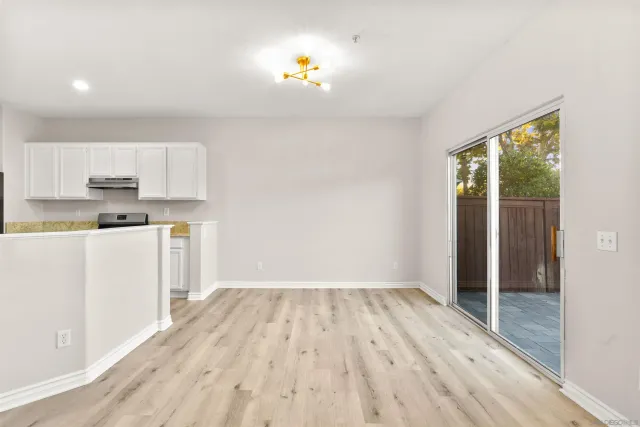 a view of kitchen with wooden floor electronic appliances and window
