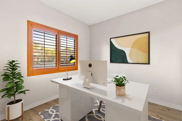 a workspace with furniture and a potted plant