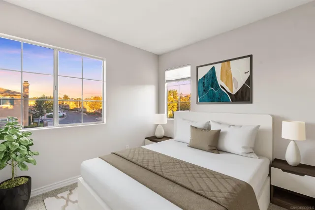 a bedroom with a bed and a painting on the wall