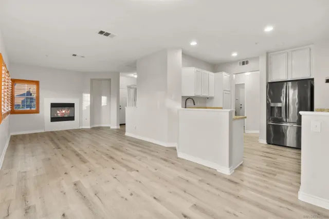a view of kitchen with refrigerator microwave and wooden floor