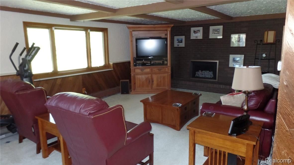 36214 Smithfield Road Farmington, MI 48335 - Photo 11 of 41 Family room has park views and modern fireplace with stainless trim