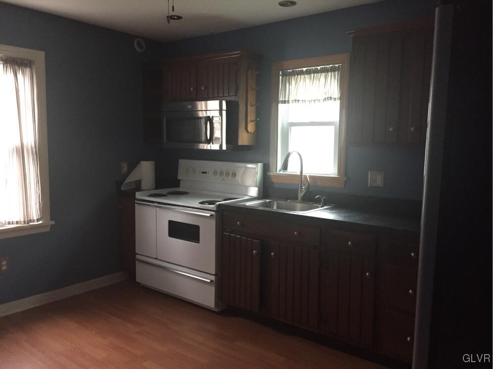 485 Sportsman Club Road Nazareth, PA 18064 - Photo 5 of 9 a kitchen with granite countertop white cabinets and black appliances