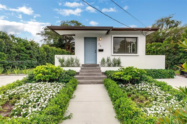 a front view of a house with garden