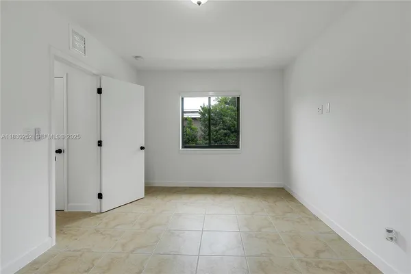 a view of an empty room with a window