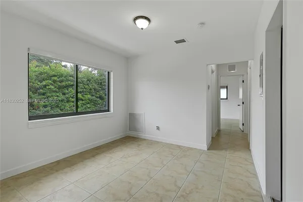 a view of an empty room with a window