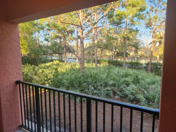 a balcony with trees in front of it