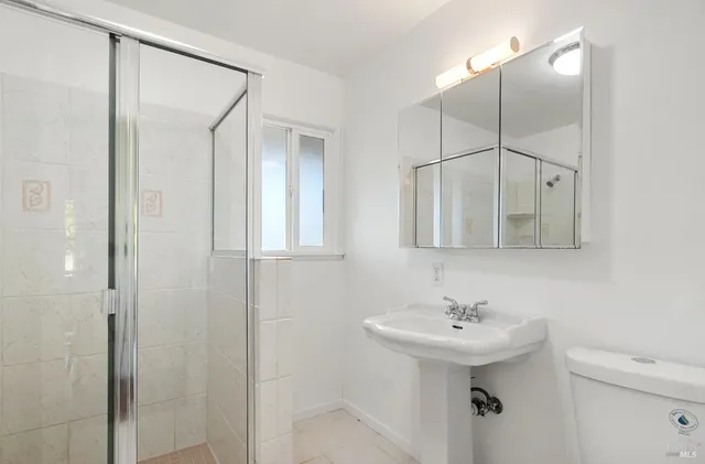 a view of a house with a tree in the background