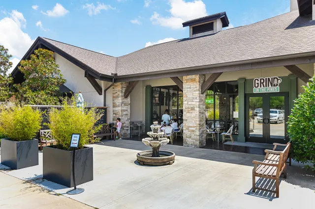 a building outdoor space with patio furniture and potted plants