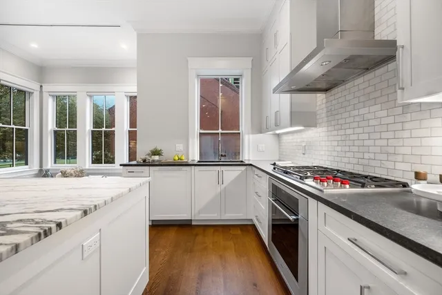 a kitchen with stainless steel appliances granite countertop a sink and stove