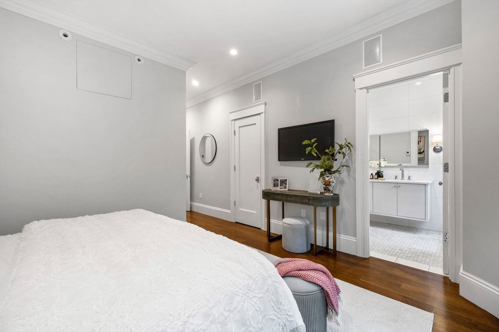 82 Worcester Street, Unit 2 Boston, MA 02118 - Photo 18 of 32 a bedroom with a bed and a flat screen tv