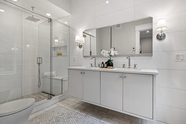 a bathroom with a shower sink vanity and mirror