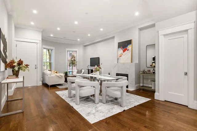 a living room with lots of furniture and a view of kitchen