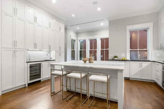a kitchen with kitchen island granite countertop wooden cabinets and white appliances