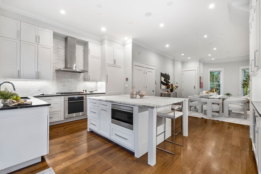 82 Worcester Street, Unit 2 Boston, MA 02118 - Photo 10 of 32 a kitchen with a stove and a white wooden cabinets