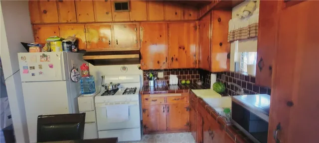 a kitchen with a refrigerator and a stove