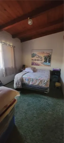 a bedroom with a bed and a chair
