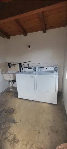 a front view of house with yard and trees around