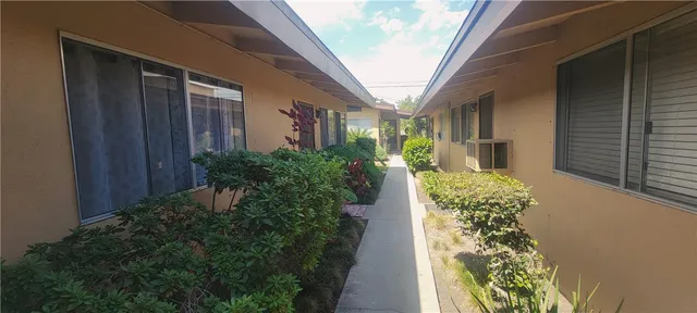 a view of a house with potted plants