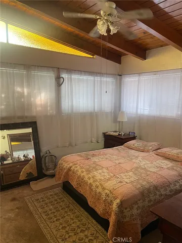 a bedroom with a bed and a mirror