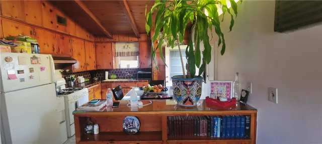 a kitchen with stainless steel appliances a stove a sink and a refrigerator