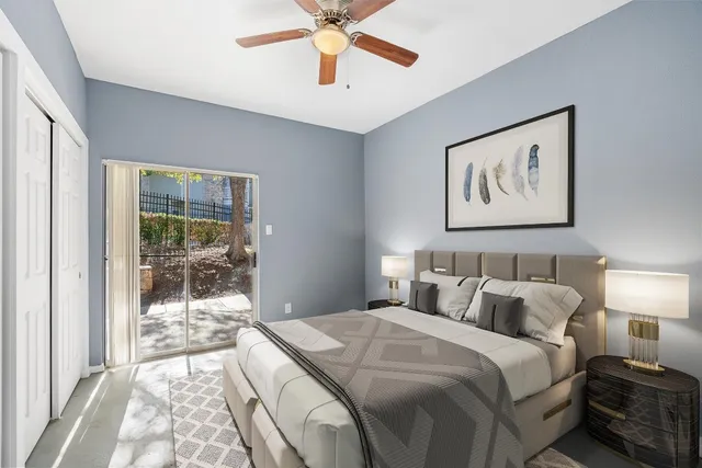 a bedroom with a large bed and a chandelier