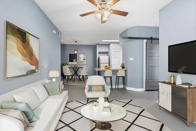 a living room with furniture and a flat screen tv