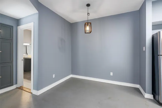 an empty room with a empty space and windows