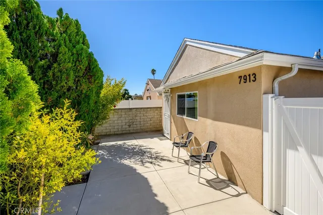 a view of a patio with table and chairs and potted plants