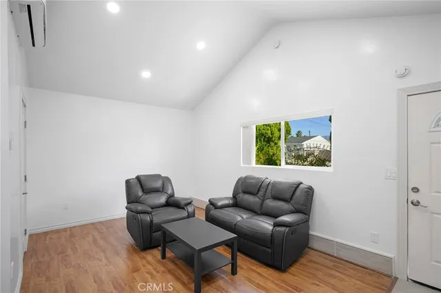 a living room with furniture window and wooden floor