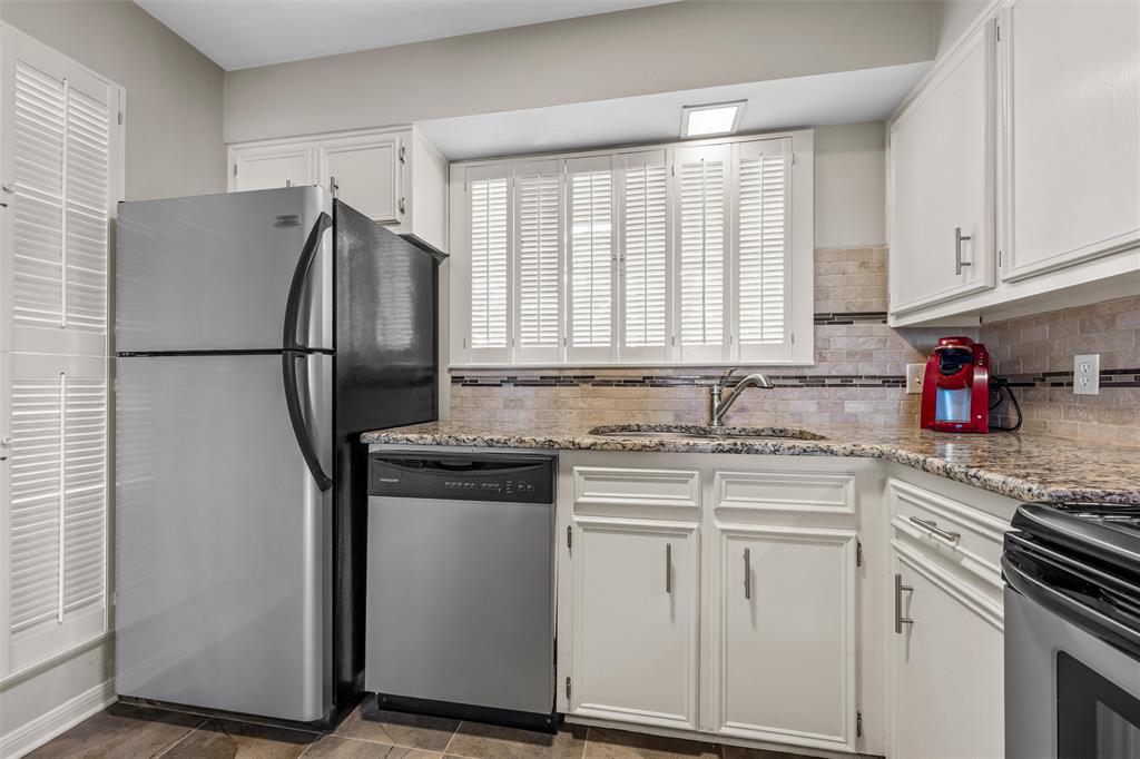 2901 Lake Shore Drive, Unit 405 Waco, TX 76708 - Photo 12 of 31 a kitchen with appliances a sink and cabinets