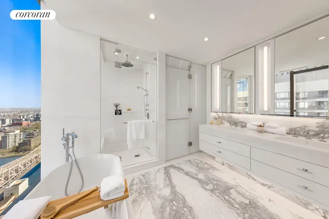 a bedroom with a large bed couch and a window