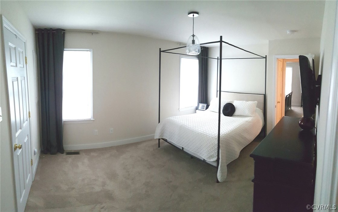 11437 Chester Road Chester, VA 23831 - Photo 18 of 25 a bedroom with a bed and a window