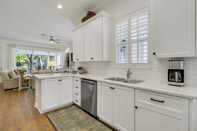 a view of a dining room with furniture a chandelier and wooden floor
