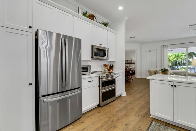 a view of a dining room with furniture wooden floor and chandelier