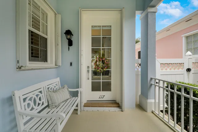 a living room with furniture kitchen view and a window