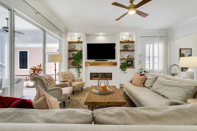 a dining room with furniture a chandelier and wooden floor