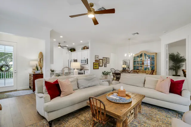a view of a dining room with furniture a chandelier and wooden floor