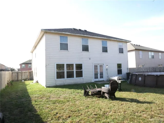 a backyard of a house with yard fire pit and outdoor seating