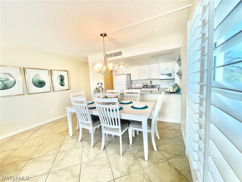 2521 Beach Villas Captiva, FL 33924 - Photo 13 of 50 a dining room with furniture and a floor to ceiling window