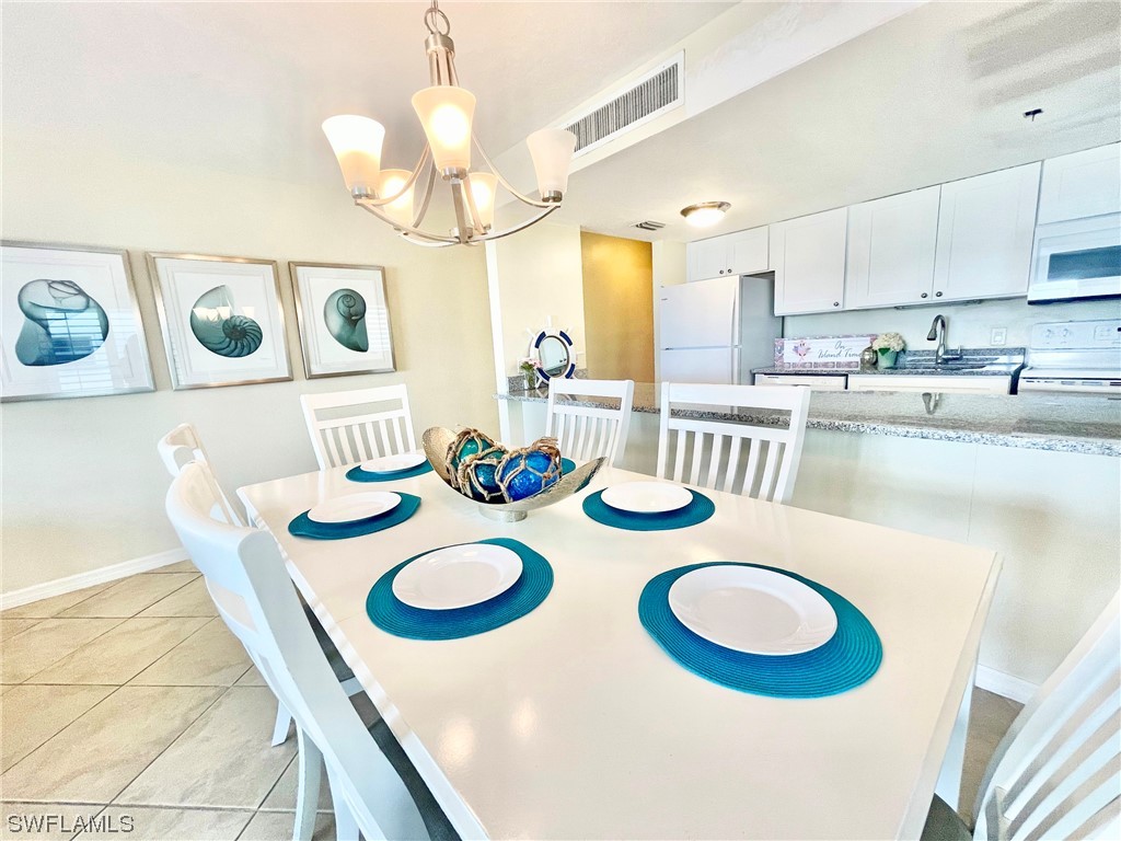 2521 Beach Villas Captiva, FL 33924 - Photo 15 of 50 a kitchen with kitchen island stainless steel appliances table and a dining table
