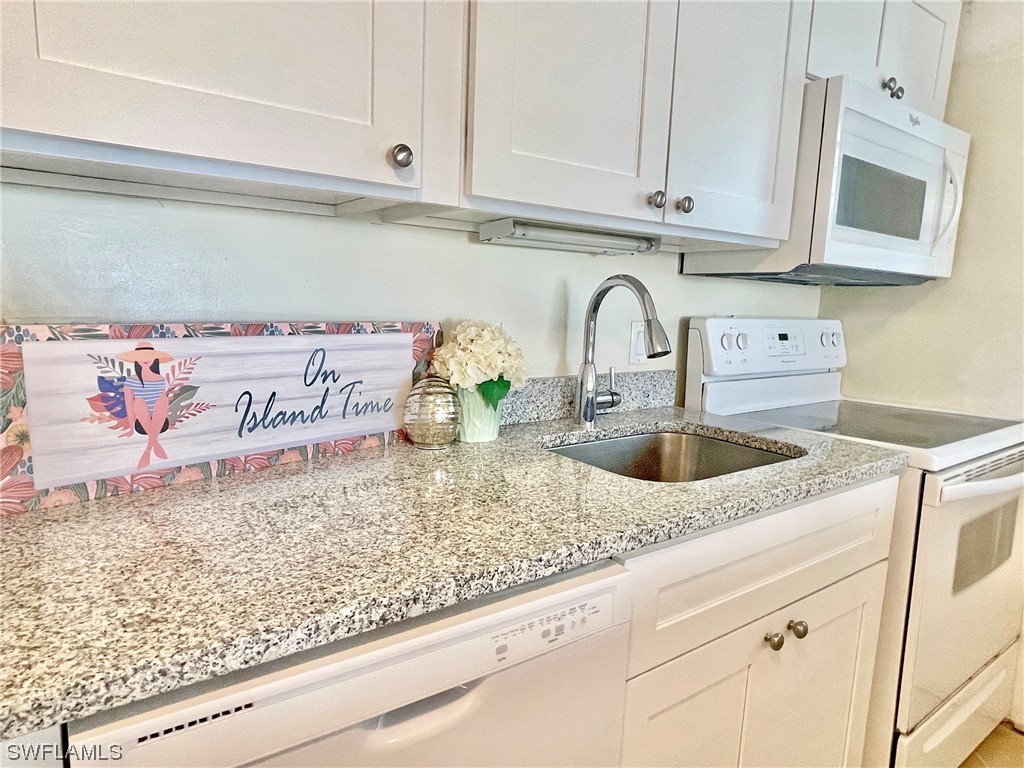 2521 Beach Villas Captiva, FL 33924 - Photo 16 of 50 a view of kitchen sink microwave and cabinets