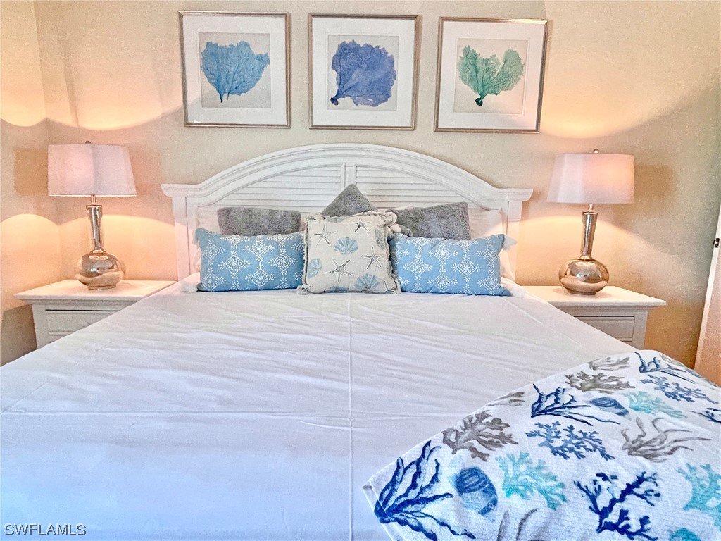 2521 Beach Villas Captiva, FL 33924 - Photo 25 of 50 a bedroom with a bed and a lamp